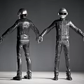 Two Men Wearing Silver Helmets And Black Leather Suits Standing In Gray Interior Space