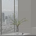 Modern Minimalist Vase with Small Flowers and Branches by White Blinds and Cabinet