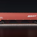 Red BNSF Freight Train Car with Number 486239 on Railway Track with Gravel