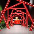 Red Geometric Art Installation With Neon Light Effect Featuring 2023TIME Text And Green Plant Decorations