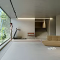 Minimalist Living Room with Large Glass Windows Trees Outside Natural Light Tan Sofa Treadmill and Staircase