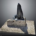 Detailed Seal Statue Perched On Weathered Stone Base With Cobblestone Pavement