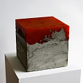 Garden Ornament Cube Shape With Red Top Gray Base And Textured Surface On White Pedestal