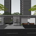 Modern Entrance Gate with Glass Structure Canopy Surrounded by Tall Buildings and Trees Fronting Driveway