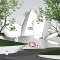 Modern Children's Play Area With White Buildings Slides Trees Green Lawn And Children Playing