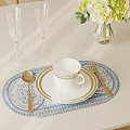 Elegant Dinnerware Set with Cup Plate Spoon Fork and Champagne Glasses on Blue White Placemat