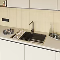 Stainless Steel Kitchen Sink with Brushed Faucet in Modern Kitchen on Beige Countertop and Glassware