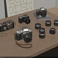 Various Digital Cameras And Multiple Lenses Arranged On Wooden Table With Decorative Painting