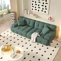 Green Tufted Two Seater Sofa With White Round Coffee Table And Geometric Rug