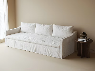 White Sectional Sofa With Wrinkled Slipcover And Wood Side Table Holding Books In Beige Room 3d model