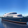 Luxury Modern Yacht Floating On Calm Water With Blue Sky And Mountains