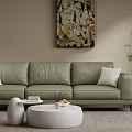 Green Leather Three-Seat Sofa With White Cushions White Round Coffee Table And Beige Wall Art