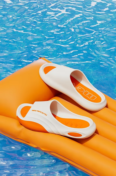 Stylish White and Orange Slippers on Orange Inflatable Float by Blue Pool Water 3d model