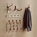 Various Metal Wall Hooks On Wooden Surface With Hanging Striped Coat