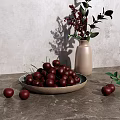 Fresh Red Cherries in Ceramic Bowl on Gray Countertop with Vase and Green Leaves