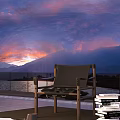 Outdoor Leisure Chair with Metal Frame and Canvas Seat Enjoying Sunset Over Mountain and Lake View