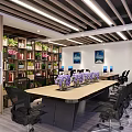 Modern Public Office Space Featuring Long Table Purple Flowers Black Office Chairs Bookshelves Green Plants