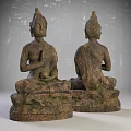 Two Seated Buddha Sculptures With Intricate Carving Details And Textured Surfaces