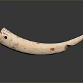 Ivory Colored Horn Shaped Household Item With Red And Black Decorative Patterns