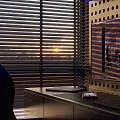 Modern Desk Setup With Laptop Tablet Sunset Light Near Blinds Displaying Design On Screen