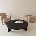 Beige Armchairs And Black Round Coffee Table With Open Book In Minimalist Space