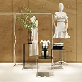 Metallic Display Shelves In Modern Showcase Area With Mannequin White Dress Plants And Books