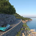 Scenic Coastal Road Along Cliff With Green Trees Blue Sky Blue Sea And Distant Ship