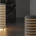 Illuminated Cylindrical Striped Floor Lamps In Modern Indoor Space With Stone Walls