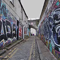 Vibrant Commercial Street Featuring Graffiti Covered Buildings Cobblestone Path and Distant Archway