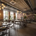 Industrial Style Hotpot Restaurant Interior With Brick Walls Hanging Lights Dining Tables And Green Plants