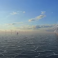 Scenic Offshore Wind Turbines At Sunset With Blue Sky Clouds And Rippling Sea