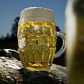 Scenic Water Landscape With Rocks Beer Bottle Mug And Green Limes