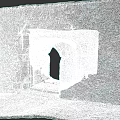 Ancient Stone Gate With Archway Design In Stone Wall And Stone Steps Near Grass Area
