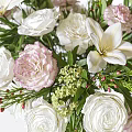 Elegant Floral Arrangement In Clear Glass Vase With White Roses Pink Blooms And Green Foliage
