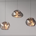 Three Modern Irregular Shaped Glass Pendant Lights with Warm Illumination and Contemporary Design