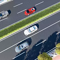 Different Colored Cars Driving On Highway With Green Median And Trees
