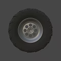 Off Road Vehicle Tire With Deep Tread Pattern And Silver Alloy Rim
