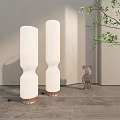 Modern Floor Lamps with White Pleated Shades and Wooden Bases in Interior with Decorative Figurine
