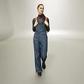Woman in Denim Overalls and Black Turtleneck Walking in Gray Studio Space