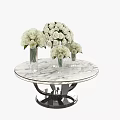 Round Marble Top Coffee Table With Black Base Glass Vases And White Roses