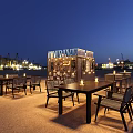 ORPHEE Open Air Bar Night Scene With Outdoor Tables Chairs And Ambient Lighting