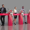 People In Formal Attire At Red Pedestals With Flower Arrangements And LOGO Ceremony Event