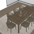 Wooden Outdoor Table With Rattan Chairs And Decorative Vase Fruit Bowl Setting