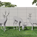 Landscape Sculptures Featuring Three White Deer On Green Grass With Wall And Trees Under Sky