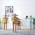 Straw Scarecrow Decorations With Abstract Wall Art And Potted Green Plants In Indoor Setup