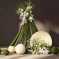 Indoor Floral Installation With Green Stems White Flowers Round Spheres And Beige Fan