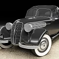 Classic Black Vintage Car With Round Headlights And Chrome Grille Design On Concrete Surface