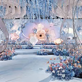 Elegant Banquet Hall With Floral Decorations Hanging Installations And White Chairs