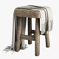 Natural Wooden Stool With Gray Fringed Blanket Draped Over Rustic Structure