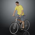 Man in yellow T-shirt and shorts riding a bicycle against gray background